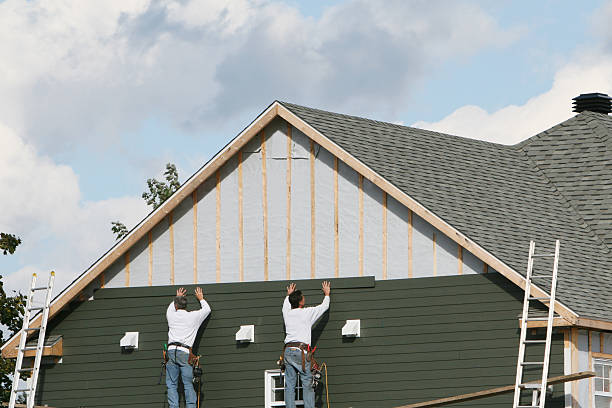 Professional Storm Damage Siding Repair technician working in North Bend, OH